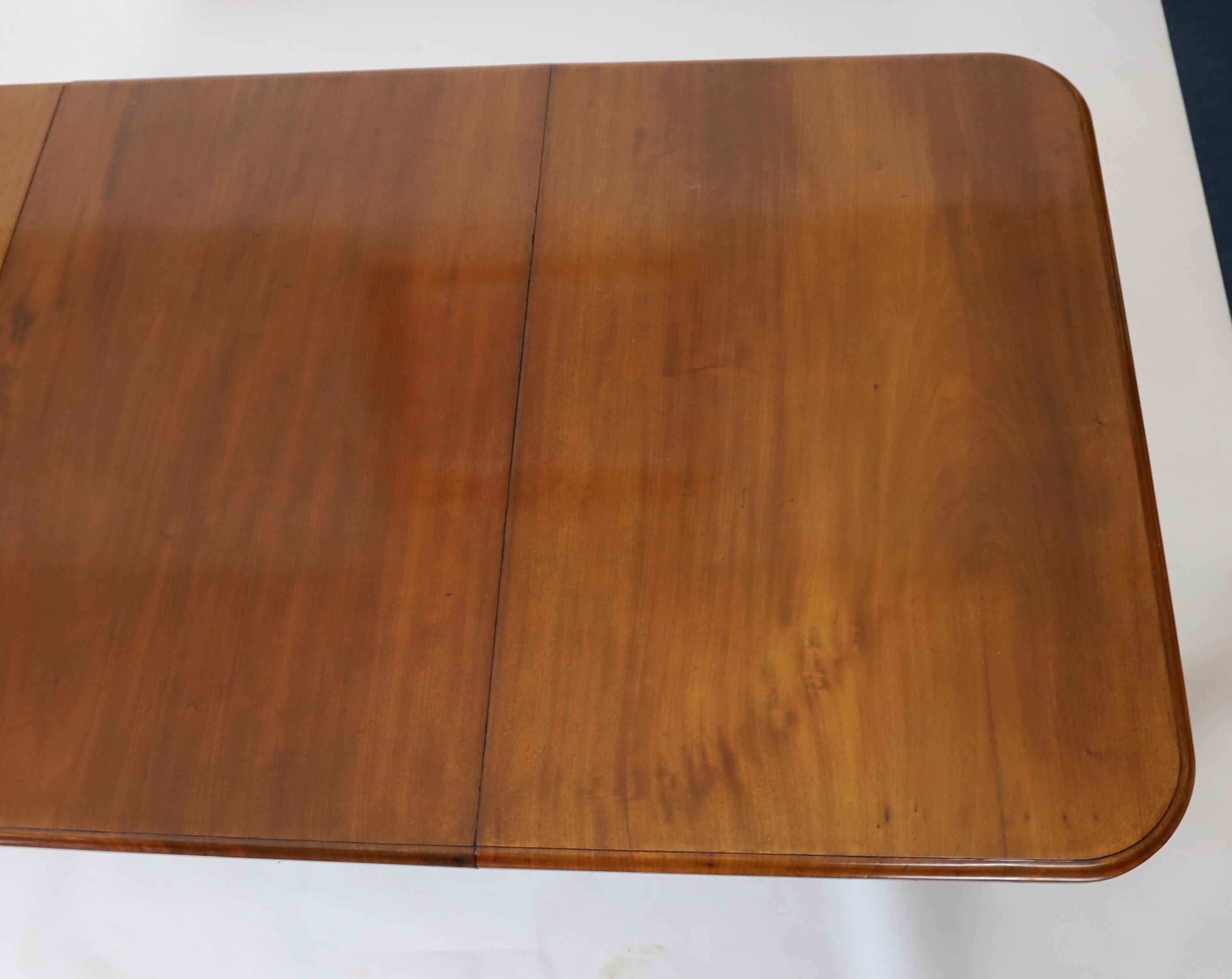 A mid Victorian mahogany extending dining table, on fluted baluster legs and spoked brass castors, 355cm extended, three spare leaves, width 118cm height 73cm